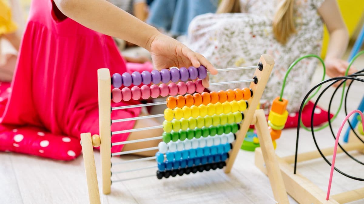 Child exploring tactile learning tools during a hands-on sensory and motor activity