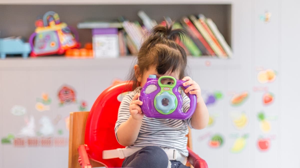 Young child engaged in play-based learning with educational toys in a bright therapy-friendly room
